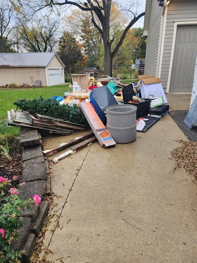 Dumpster being loaded with debris for Estate Cleanout Dumpster Rental in New Haven
